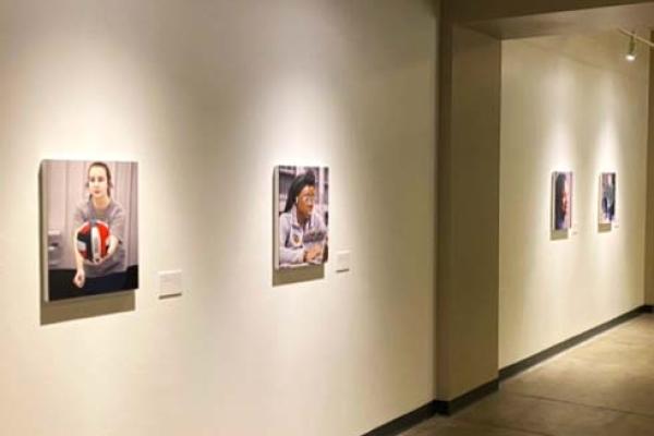 Portraits in the Behind the White Coat exhibition hanging on the wall