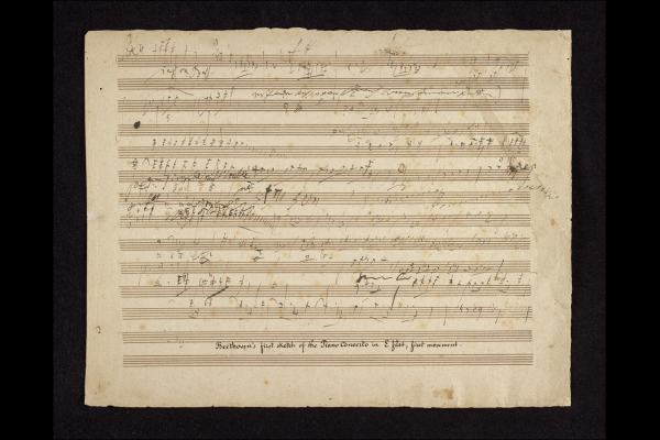 A yellowed piece of sheet music with handwritten music notes and words