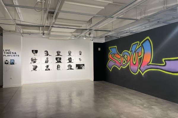 Wall featuring the word Soul in graffiti; opposite wall features digital drawings of famous Black artists