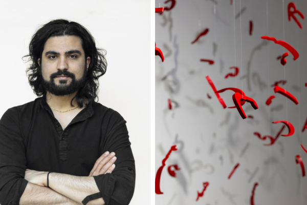 Photo of Illya beside his artwork, featuring hanging letters in Persian