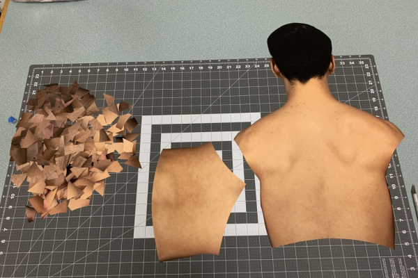 A photo showing a work in progress of a collage work by Samuel Lo, featuring a human torso