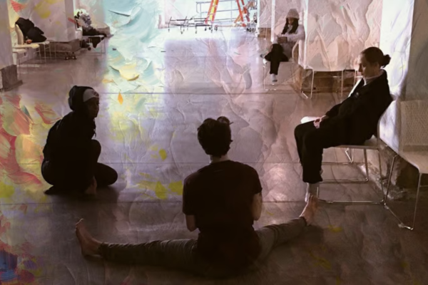 Nico and other artists of Grieving Landscapes sitting on the floor of Urban Arts Space