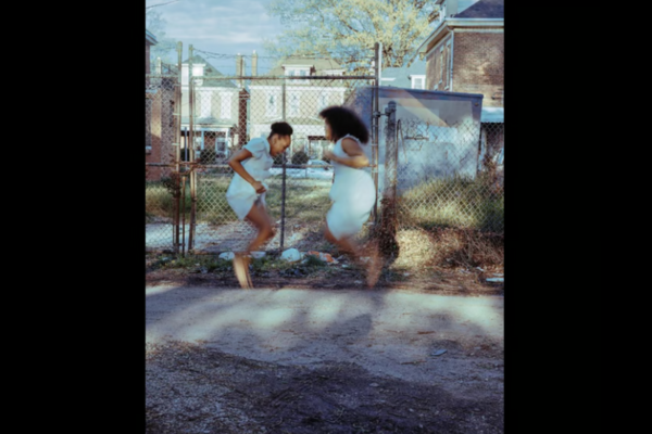 A photographic work by Ky Smiley, depicting two children jumping in the air