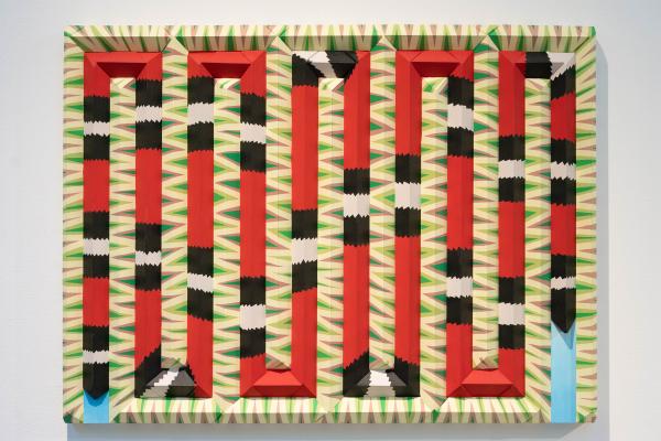 horizontal painting with snake-like lines in red, black, and green