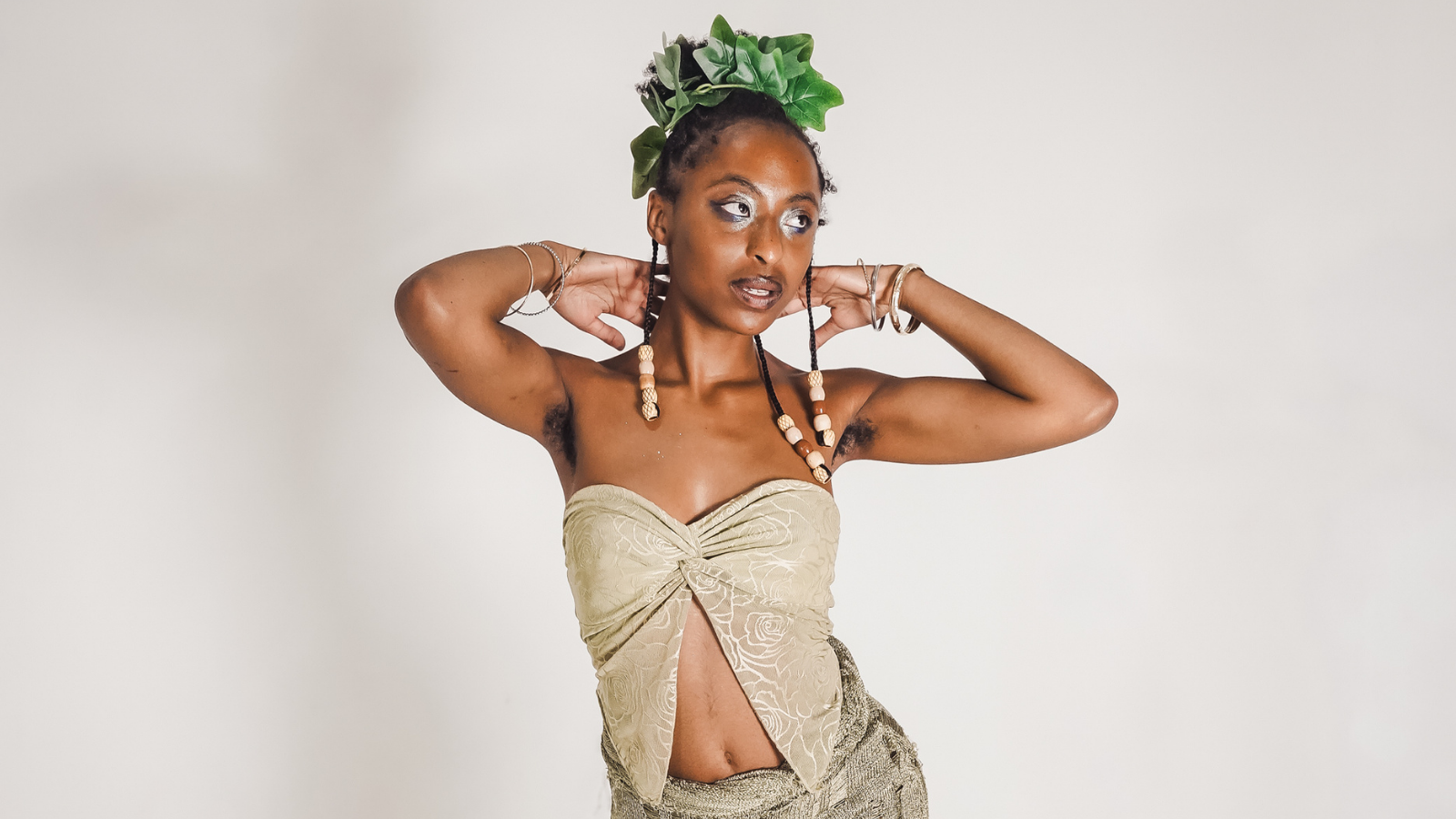 Gia sol posing in a white top and green crown