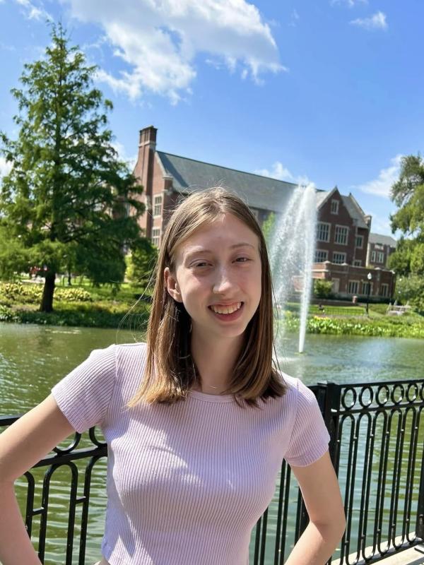 Carley Gonzalez in a print shirt in front of mirror lake