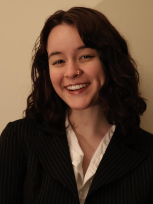 Grace smiling in a black suit jacket