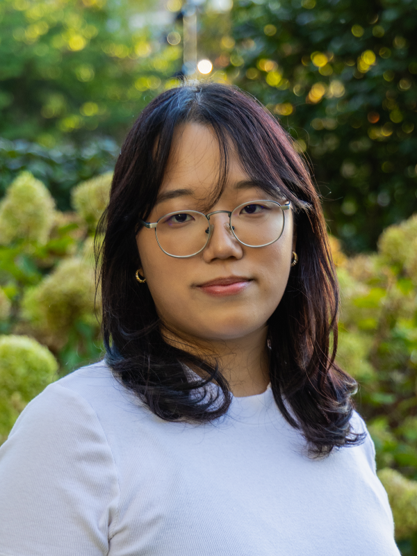 Suyeon Chae headshot with greenery in the background