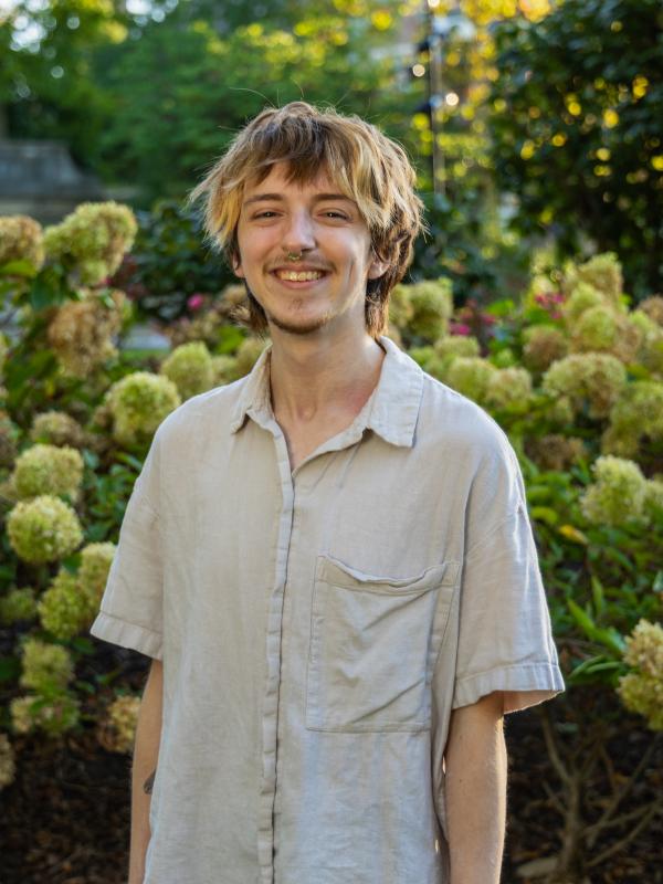 Miles smiling in front of nature
