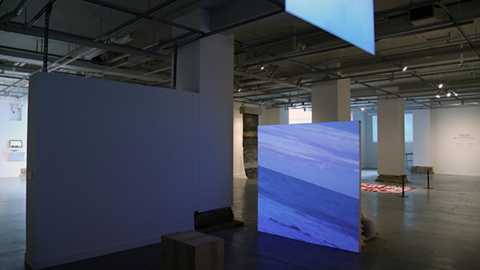 Liam Ze'ev O'Connor: "Shamayim (there are waters)," video loop, drywall, wood, 2 tons of sand, 2015