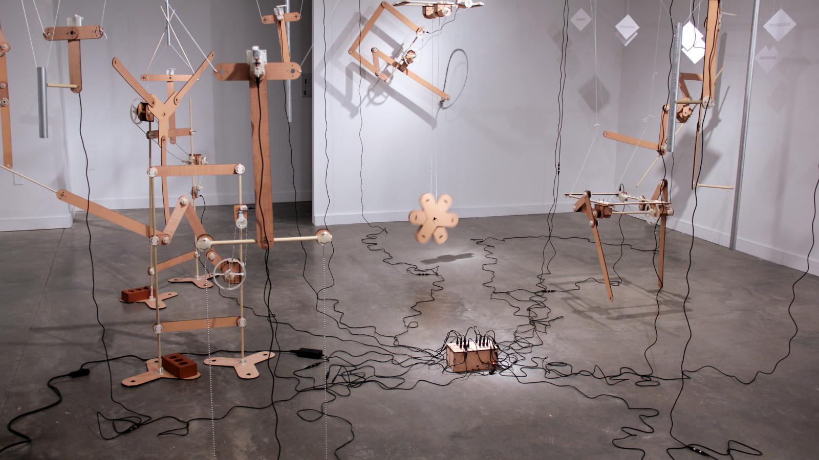 Image of Andrew Frueh: "Echo of Motion," laser-cut plywood, 3D printed PLA, nuts, bolts, wood dowels, bricks, string, 2014