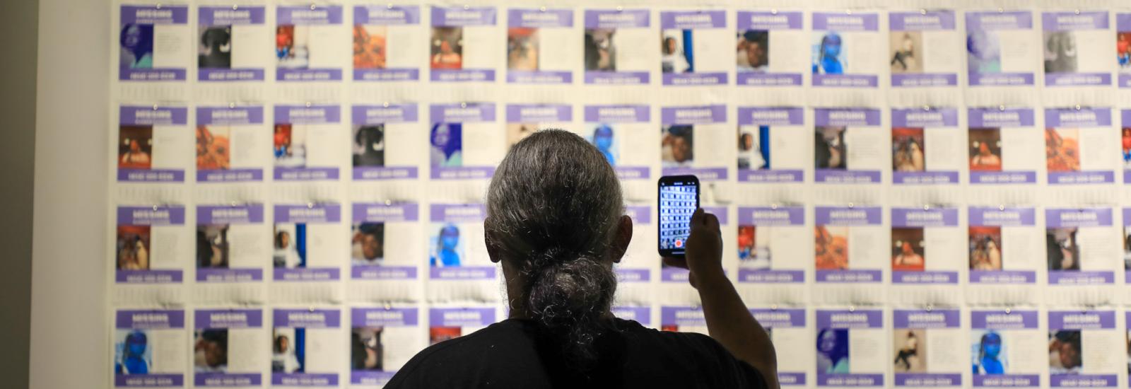 Viewer takes photo of Ajanaé's work "Missing"