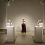 still from a dance performance, the artist is performing between sculptures